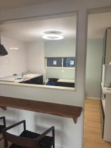 a view of a kitchen with a mirror in a room at Bluebase 波音 in Goto
