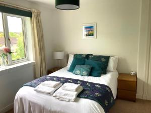 a bedroom with a bed with towels on it at The Waterside Apartment 6 in Largs