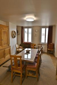 a living room with a dining room table and chairs at gîte MAELYSE in La Neuve-Lyre