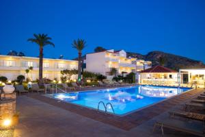 a hotel with a swimming pool at night at GK Beach Hotel in Kalyves