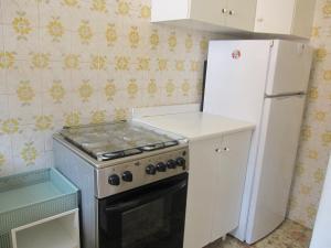 a kitchen with a stove and a refrigerator at Appartamento Island Brioni in Grado-Pineta +12 photos
