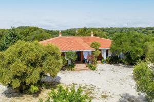 a house with an orange roof and trees at Sole in Onifai