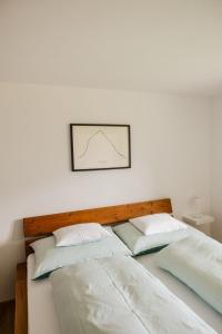 two beds in a room with a picture on the wall at Haus Hermann in Schruns