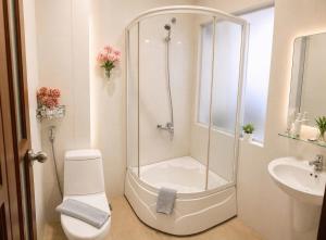 a bathroom with a shower and a toilet and a sink at Hani Motel Da Nang in Danang +11 photos