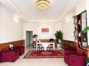 a lobby of a hotel with red chairs and a table at Hani Motel Da Nang in Danang