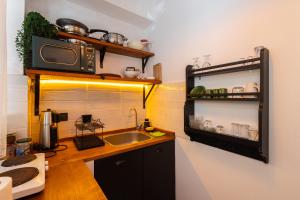 a kitchen with a sink and a microwave at 62 HOME in Marmaris