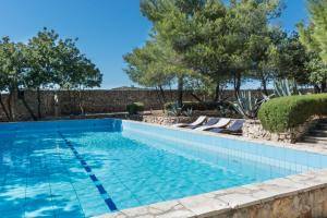 a swimming pool in a yard with trees at Ranch Frida in Vodice