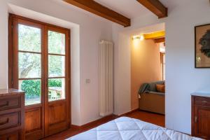 a bedroom with a door and a window at Podere Par di Rota in Calci