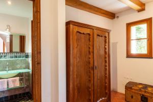 a bathroom with a wooden door and a sink at Podere Par di Rota in Calci +21 photos