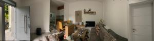 a living room with a couch and a stair case at Guest House Nuhellari - Family stay & Breakfast near Osumi Canyons in Çorovodë