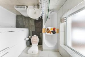 a white bathroom with a sink and a toilet at Modern House, Pool Table, Parking & Garden in Fallings Park +54 photos