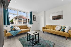 a living room with two couches and a table at Modern House, Pool Table, Parking & Garden in Fallings Park