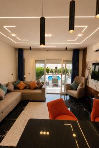 a living room with a couch and a table at Porto Matrouh Elabd Family in Marsa Matruh