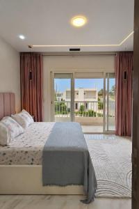 a bedroom with a bed and a large window at Porto Matrouh Elabd Family in Marsa Matruh +92 photos
