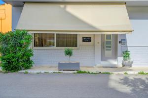 a house with a potted plant in front of it at Kalafatis Downtown Apartment in Itea
