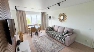 a living room with a couch and a table at Vanilla Sunrise Apartments in Sillamäe