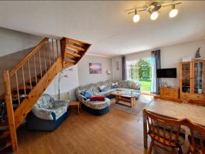 a living room with a couch and a staircase at Medemstern I in Otterndorf