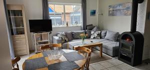 a living room with a couch and a wood stove at Medemstern II in Otterndorf