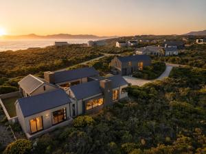 an aerial view of a house with the ocean at Cast Away at Romansbaai - Salted Fynbos Staying in Gansbaai