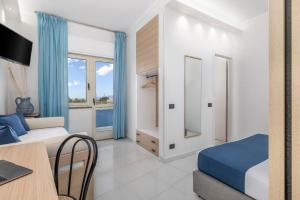 a bedroom with a bed and a desk with a laptop at Hotel Blu Eden - Calabria oltre il mare in Praia a Mare