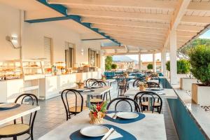 a restaurant with tables and chairs on a patio at Hotel Blu Eden - Calabria oltre il mare in Praia a Mare