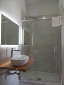 a bathroom with a sink and a glass shower at Appartamenti Tropea Gargano in Parghelia +69 photos