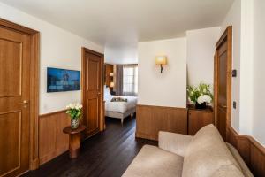 a living room with a couch and a bedroom at Hôtel Villa Madame - Saint-Germain-des-Prés in Paris