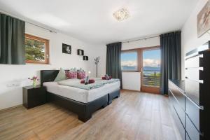 a bedroom with a large bed and a television at Villa Reny in Meltina