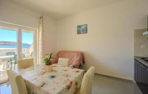 a dining room with a table and chairs and a window at Apartments by the sea Metajna, Pag - 6289 in Zubovići +40 photos