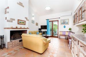 a living room with a couch and a fireplace at Sole in Onifai