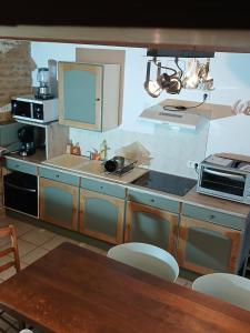 a kitchen with a sink and a stove at De l'onde au vert in Vivey +18 photos