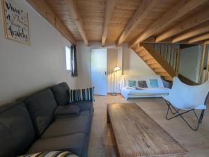 a living room with a couch and a table at De l'onde au vert in Vivey
