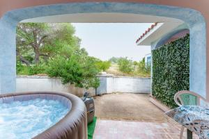 a hot tub on the patio of a house at Sole in Onifai