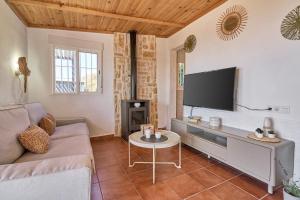 a living room with a couch and a flat screen tv at Villa Javier in Torrox