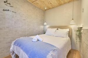 a bedroom with a bed with a towel on it at Villa Javier in Torrox +18 photos