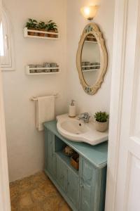 a bathroom with a sink and a mirror at Alexandra villas in Gouvia +66 photos