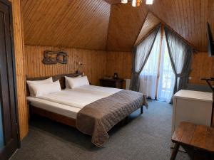 a bedroom with a bed in a wooden room at Silveroks Hotel in Bukovel +123 photos