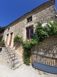 a brick building with stairs and a window at LE SOURCIER in Argançon