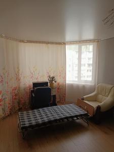 a living room with a couch and a chair at Центр,Апартаменти на Байди Вишневецького,97 in Cherkasy