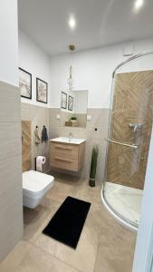 a bathroom with a toilet and a sink and a shower at Sosina Dreams in Jaworzno +31 photos