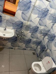 a bathroom with a toilet and a sink at Cozi Rooms in Varkala