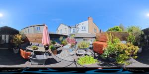 a backyard with a patio with a table and an umbrella at Avoca House in Dublin