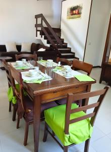 a wooden table and chairs with a table and stairs at Casa Misè in Poggio Dei Pini
