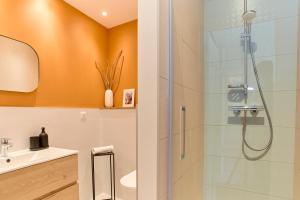 a bathroom with a shower and a toilet and a sink at Abri du vent, chambres et appartements in Fitou +88 photos