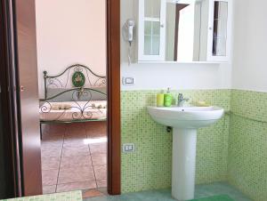 a bathroom with a sink and a bed at Casa Misè in Poggio Dei Pini +43 photos