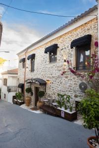 a stone building with a table in front of it at Cosmopolitan Suites in Parga