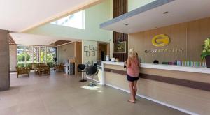 a woman standing at a counter in a lobby at Gypsy Sea View Resort- Phi Phi Island in Phi Phi Islands +89 photos