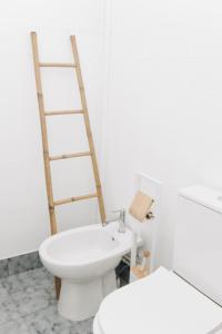 a white bathroom with a toilet and a sink at Encanto do Lima Guest House By Lethes Legacy in Ponte de Lima +24 photos
