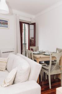 a living room with a white couch and a table at Encanto do Lima Guest House By Lethes Legacy in Ponte de Lima