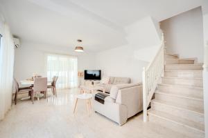 a living room with a couch and a table at Salt & Sun Retreat in Perivolia